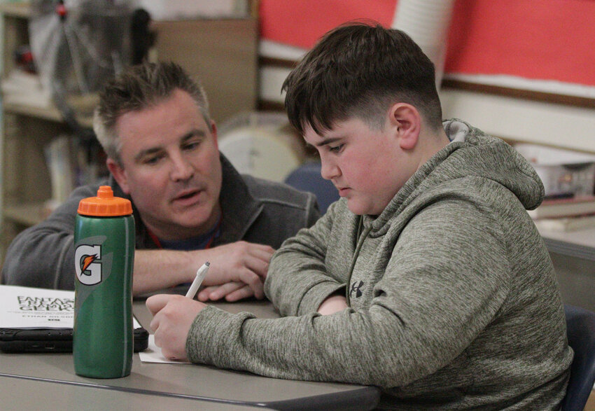 ELA teacher Jim Murray works with student Erol Fikri during a session with author Ethan Gilsdorf.