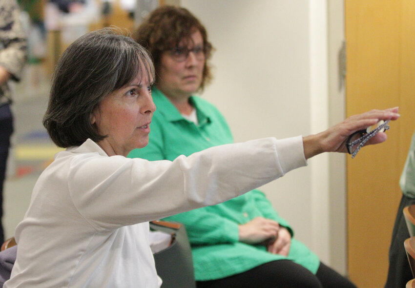 Bristol resident Paula Martel, shown asking a question during Monday’s forum, at one point got frustrated with the presentation by Rhode Island Energy officials and said, “Year over year, you’re using less energy, but your bill is doubling.”