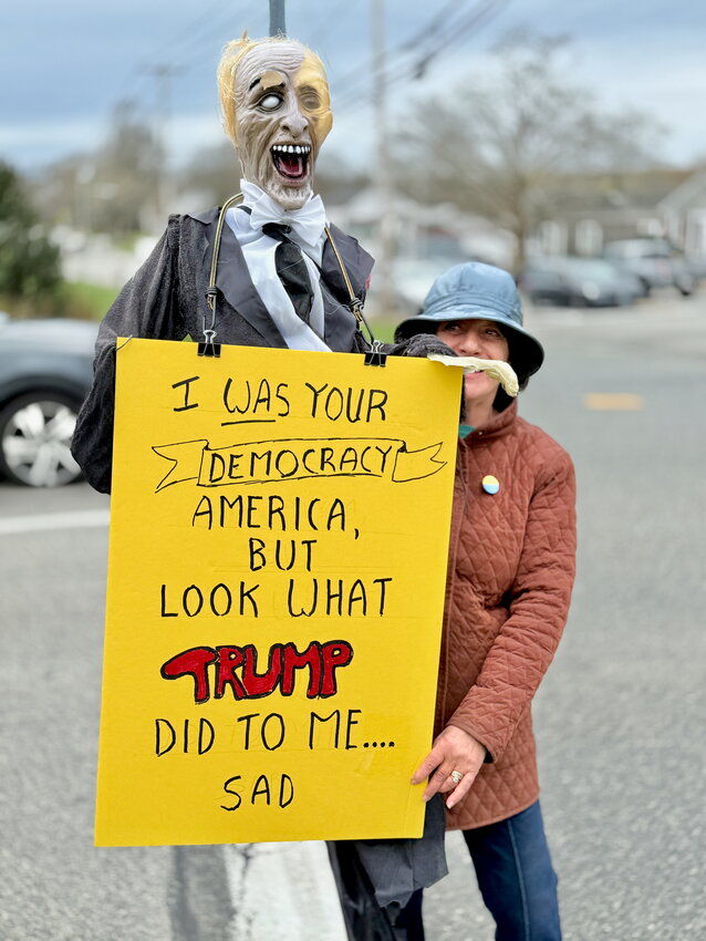 “The very democratic ideals that our country was founded on? We’re losing them,” said Mary Lorusso-DiBara, who attended the protest with this eye-catching prop and sign.