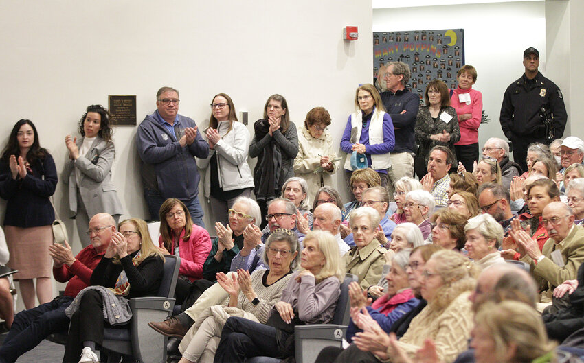 Members of the audience inside the Portsmouth Middle School auditorium applaud a point made by one of the congressmen.