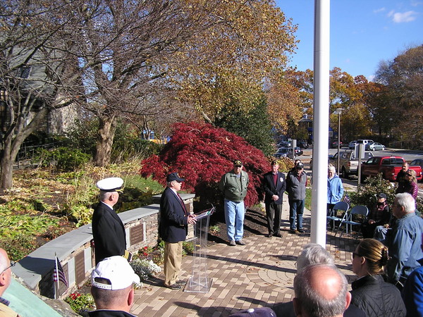 Barrington residents participate in a prior year's Veterans Day ceremony. The Barrington UVC said it will likely relocate this year's event away from the veterans memorial &quot;if the Town Council continues to fly unofficial political banners over our memorial.&quot;
