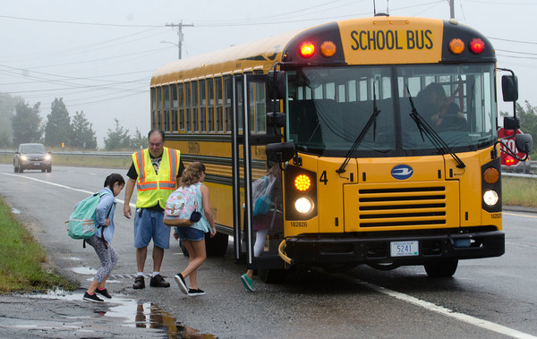 A bus picks up Barrington students on the Wampanoag Trail last year. Members of the union who serve as drivers and monitors for the bus company voted recently to authorize a strike.