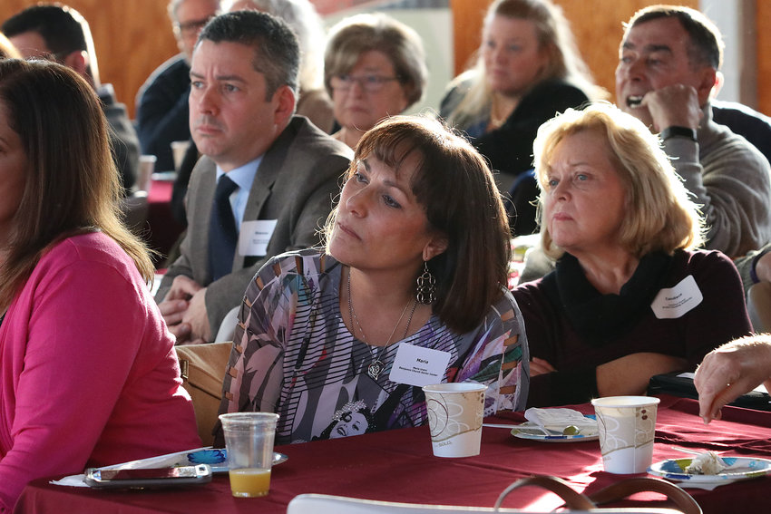 Maria Ursini (with Bristol Town Administrator Steve Contene visible behind her), attend a Chamber of Commerce meeting in 2019.