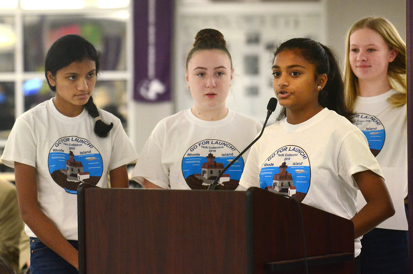 Shivani Mehta speaks about their &ldquo;Go For Launch&rdquo; project during the Bristol Warren school committee meeting Tuesday night, with teammates (from left), Aditi Metha, Mykala Hudon and Kristiana Cabral looking on.