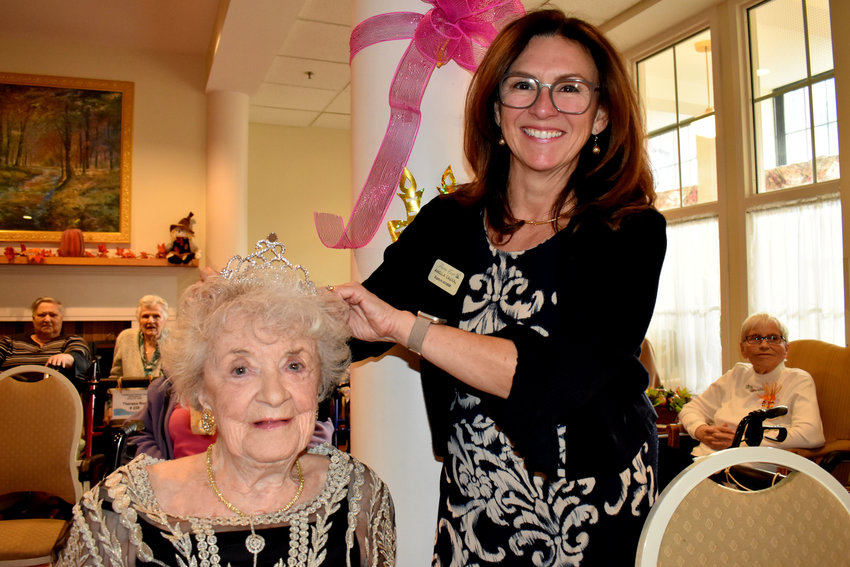 Mary Quinn (left) gets the crowning touch from Franklin Court Assisted Living Administrator Angela P. Cabral during her 100th birthday celebration.