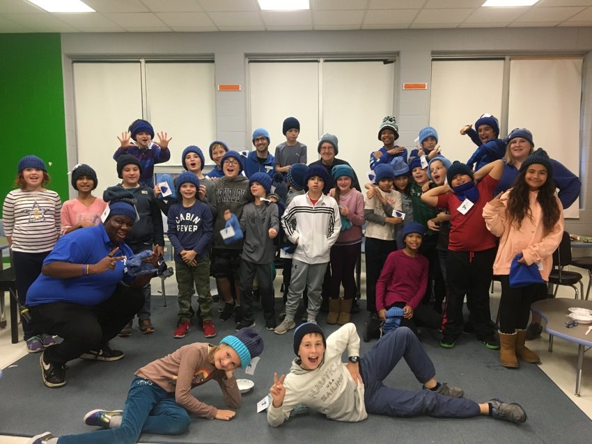 Students in the Hampden Meadows School YMCA After-school enrichment program show off their new blue hats. The hats are part of the Hat Not Hate program, which works to eradicate bullying.