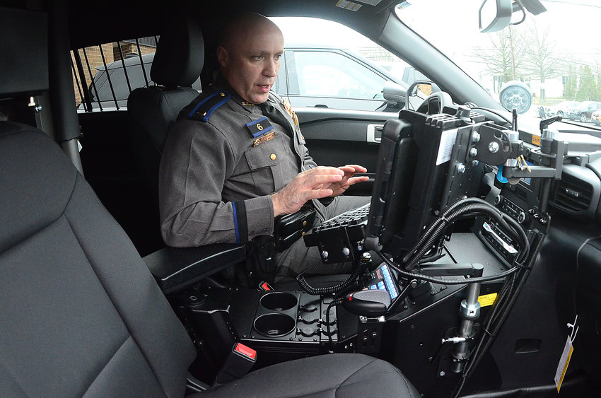 Police Lt. Roman Wozny demonstrates how to use some of the new technology in the marked vehicle.
