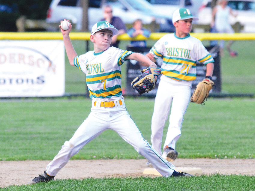 Logan Dubois fires a throw to first base during a King Philip Little League all-star game last summer.