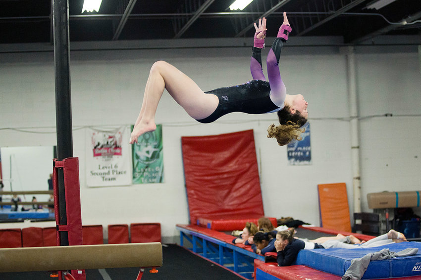 Molly Thibaudeau dismounts from the beam during a home meet against  South Kingston, Tuesday, January 21st.