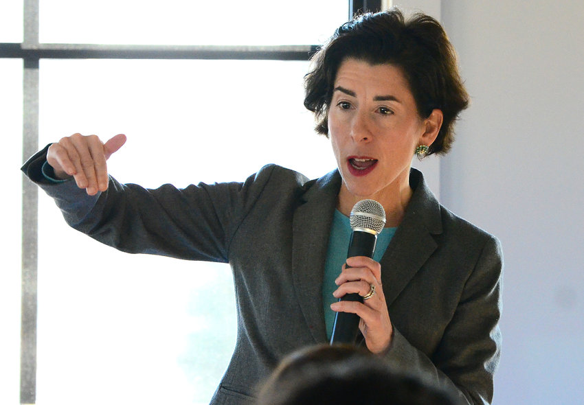 Gov. Gina Raimondo talks to a large crowd inside a large, elegant room at WaterRower in Warren.
