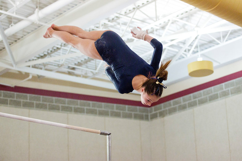 Barrington's Shaye Robinson dismounts from the uneven bars while competing at the State Gymnastics meet, Saturday.