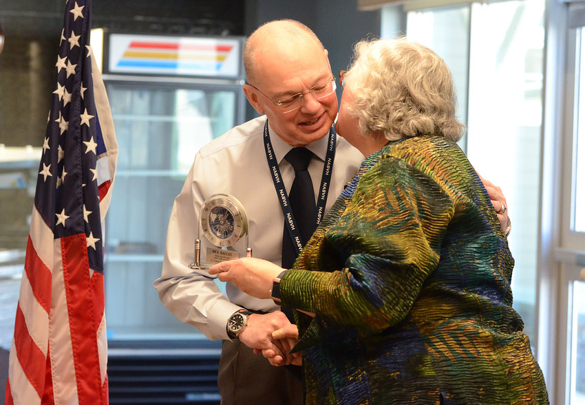 Brig. Gen. Rick Baccus gets a congratulatory embrace from Donna St. Angelo, chairwoman of the Veterans&rsquo; Home Family Council, during an appreciation ceremony for the retiring veterans&rsquo; home director.