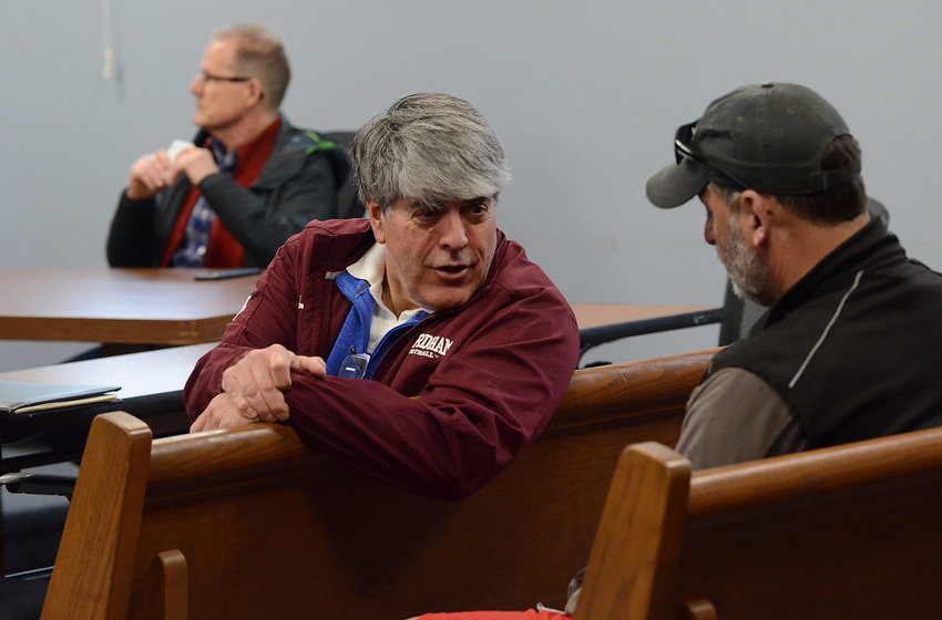 Warren Town Solicitor Anthony DeSistor (center) speaks with Warren Town Council member Steve Calenda (right) at a recent council meeting. At left rear is councilor Brandt C. Heckert.