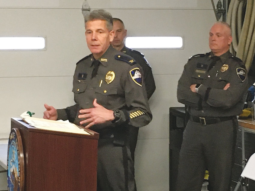 Bristol Police Chief Kevin Lynch talks to members of the command team, including captains Brian Burke (rear, left) and Scott McNally, during a meeting held in the station garage to allow adequate social distancing.