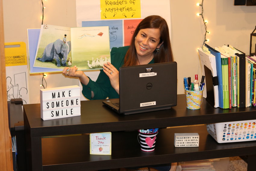 Hathaway Elementary School third-grade teacher Ashley Adamson reads to her class from her basement at home. In addition to running their morning meetings as usual, Ms. Adamson and her co-teacher, special educator Victoria Travis, have sent handwritten cards to their students.