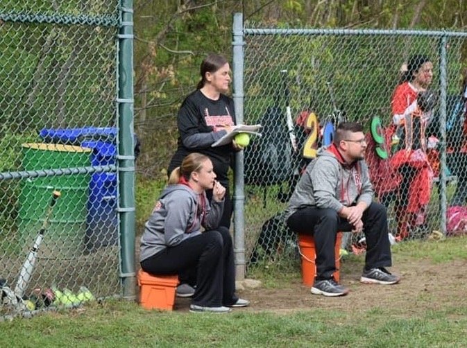 New East Providence High School softball coach Katie Kenahan (left) watches her former Riverside Middle School squad play a game last year. Kenahan was assisted at RMS by her mother Linda Gorton (standing) and Paul Mendence (right), who will also serve as her aides when the Townies return to action next spring.