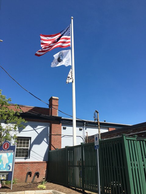Without a strong wind, the Black Lives Matter flag is difficult to see beneath the U.S. and Rhode Island flags, but it hangs over Bristol Town Hall for the remainder of June.