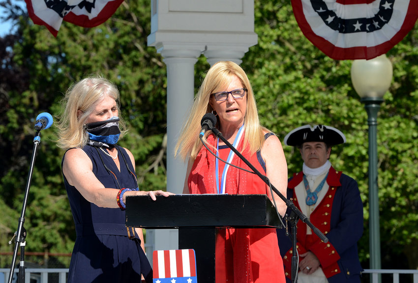 Linda Bushee looks on as her sister, 2020 Bristol Fourth of July Parade Chief Marshal Suzanne Magaziner makes her Flag Day speech.