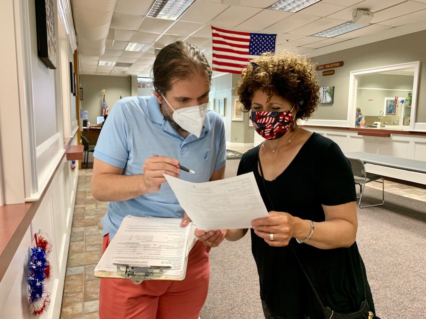 Roxanne Giusti-Lavoie, former owner of Roxie&rsquo;s consignment clothing store, here getting assistance from Republican Will Grapentine, turns in her papers to run for Bristol Town Council as an Independent.