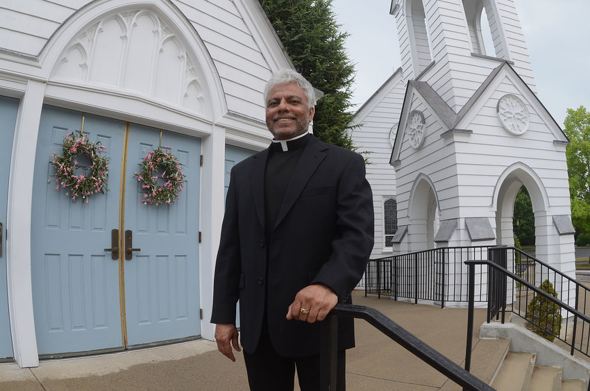 St. Luke's Church pastor Father TJ Varghese stands in front of the church for a photograph last week. On Sunday, Father Varghese celebrated his final weekend Mass at the Barrington church. This week, Father Varghese starts his new assignment at Mary, Mother of Mankind parish in North Providence. &quot;I am going to miss this place. It is a jewel,&quot; Father Varghese said of St. Luke's.
