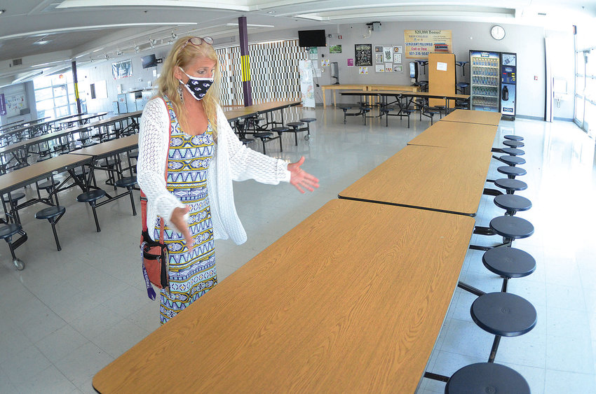 Mt. Hope High School Principal Deborah Dibiase shows the school's cafeteria during a tour a few weeks ago. They expect to seat one student per table this year.