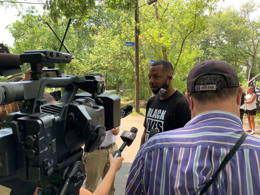Black Lives Matter organizer Mark Fisher talks to the media at Rumstick Point Tuesday afternoon.