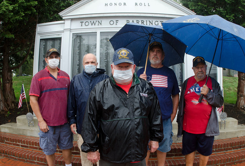 Members of the Barrington United Veterans Council (from left to right) Paul Dulchinos, Bill Groves, Joe Macrae, Al Girard and Luigi Carusi, stand in front of the town's Honor Roll on Monday afternoon. The Barrington UVC will hold a rally on Oct. 5 to protest the town's decision to fly &quot;private/political&quot; flags on the town hall flag pole above the veterans memorial.