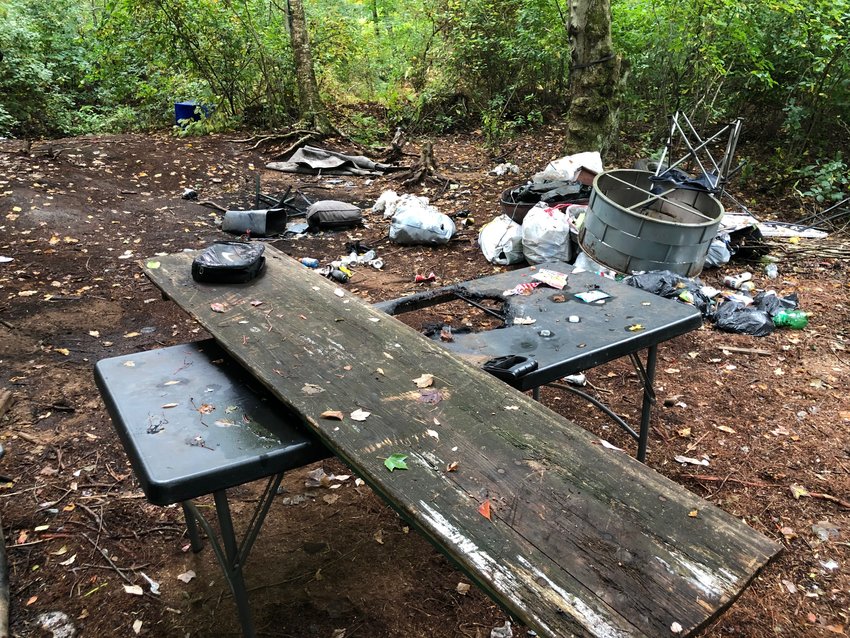 A large board rests upon a folding table found at the makeshift campsite.