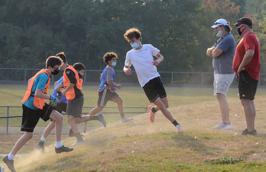 Mt. Hope boys' soccer team players work on a conditioning drill during a recent practice. Those students who are going into the building one day per week will soon be switching to two days per week.