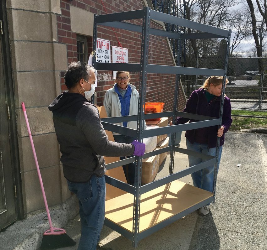 Volunteers move items out of Tap-In's headquarters in the Peck Center building in April. In October, the agency will re-locate back to the Peck Center after operating out of the Barrington Presbyterian Church for six months.