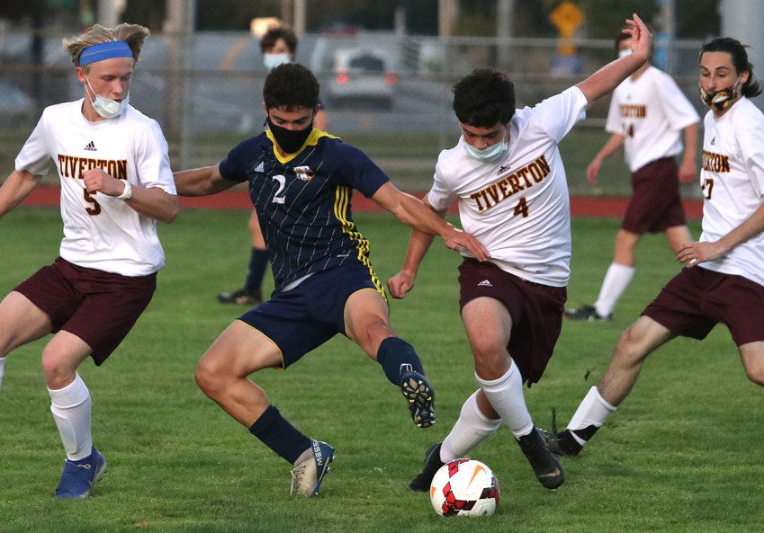 Barrington High School's Nico Arce (middle) battles two Tiverton players for control of the ball during the Eagles' non-league game against the Tigers last week. The two teams played to a 0-0 tie.