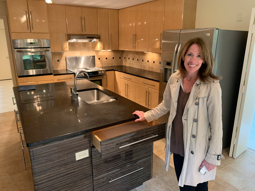 Beth Anderson, an agent for Mott and Chace Sotheby's International, stands inside the kitchen of a Spinnaker Drive home that is for sale. Barrington is experiencing a strong sellers market currently.