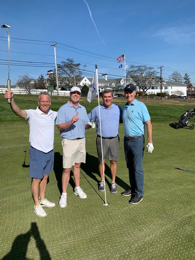 Steve Tortolani, Mike Dolan, Brad Dimeo and Mike Mahoney (from left to right) pose for a photo following Mr. Dolan's hole-in-one on the 18th hole at Rhode Island Country Club on Saturday.