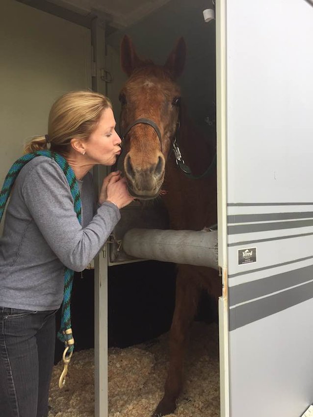 The letter&rsquo;s author, Amy Rice, kissing her horse Reina.