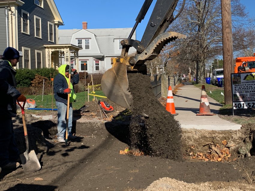 Workers from ELJ and a Milton Costa&rsquo;s landscaping crew work on a patch of sidewalk and driveway on the west side of Hope Street Wednesday morning. Crews hired by the town are working on sidewalks from Silver Creek to the entrance to Colt State Park.