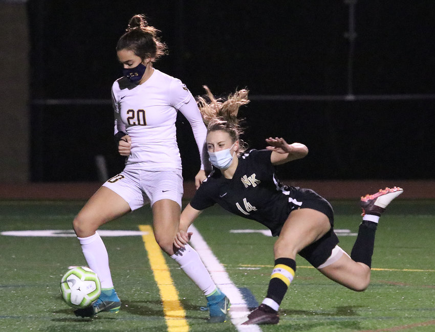 Barrington High School senior forward Tess Gagliano steadies as a North Kingstown defender falls trying to stop her on a through pass up the middle in the first half of the quarterfinal game on Tuesday night at North Kingstown.