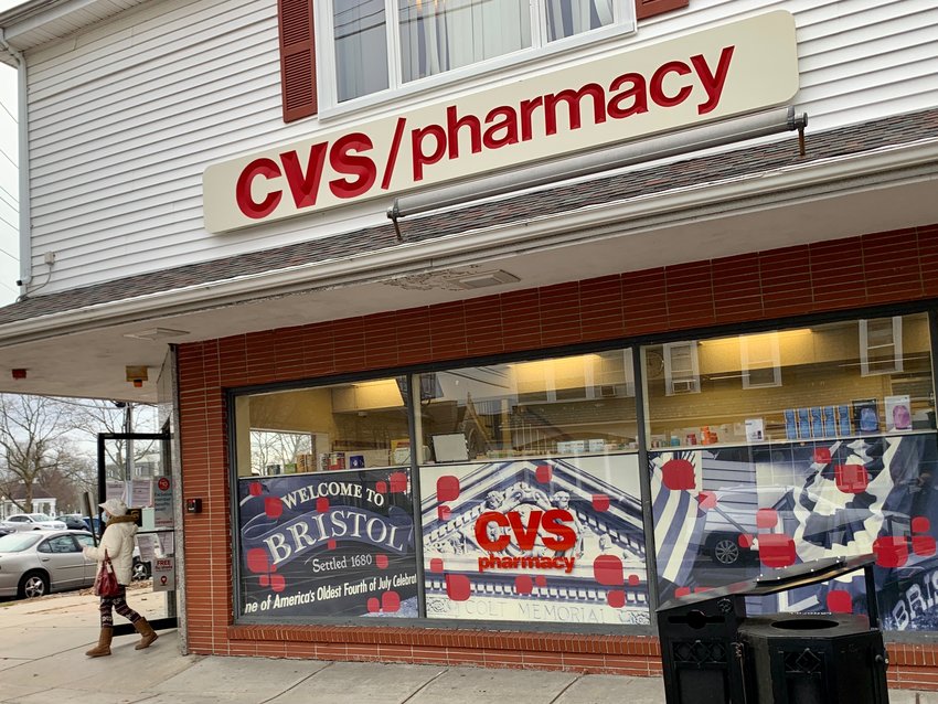 A customer walks out of the CVS at the corner of Wood and State streets downtown on Wednesday morning. The pharmacy will close next week.