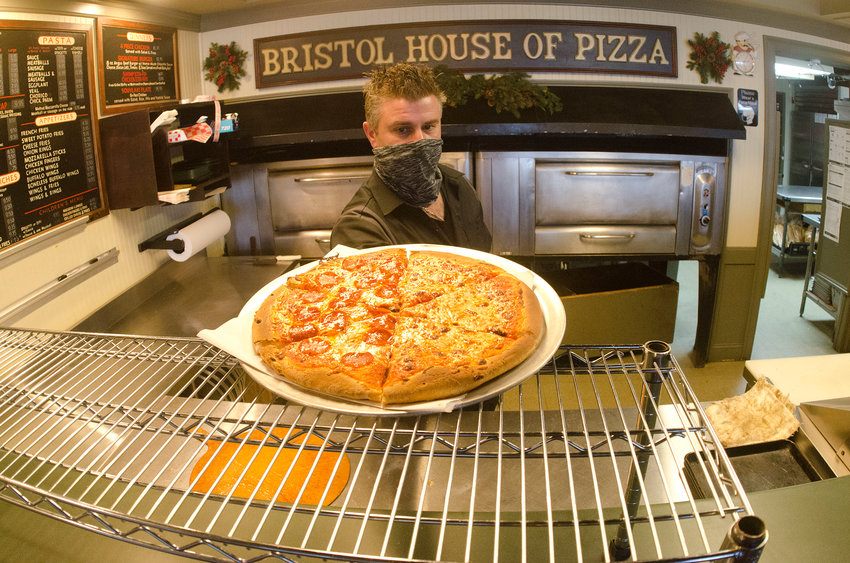 Greg Gatos, co-owner of Bristol House of Pizza, works in the kitchen on Tuesday. A week ago, his family business was granted a license upgrade, from beer and wine to full liquor.