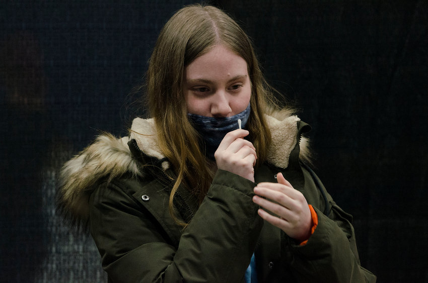 Isabel, a freshman from Rockland, N.Y., swabs her nose as part of the coronavirus test.