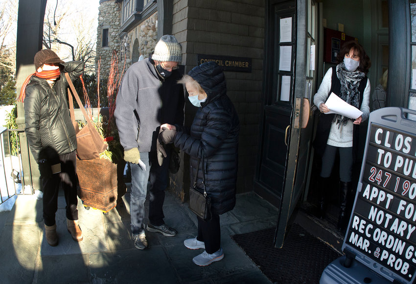 Barrington resident Ruth Oppenheim (third from left) heads back to her car after discovering she was not able to register for a vaccination on Friday morning.