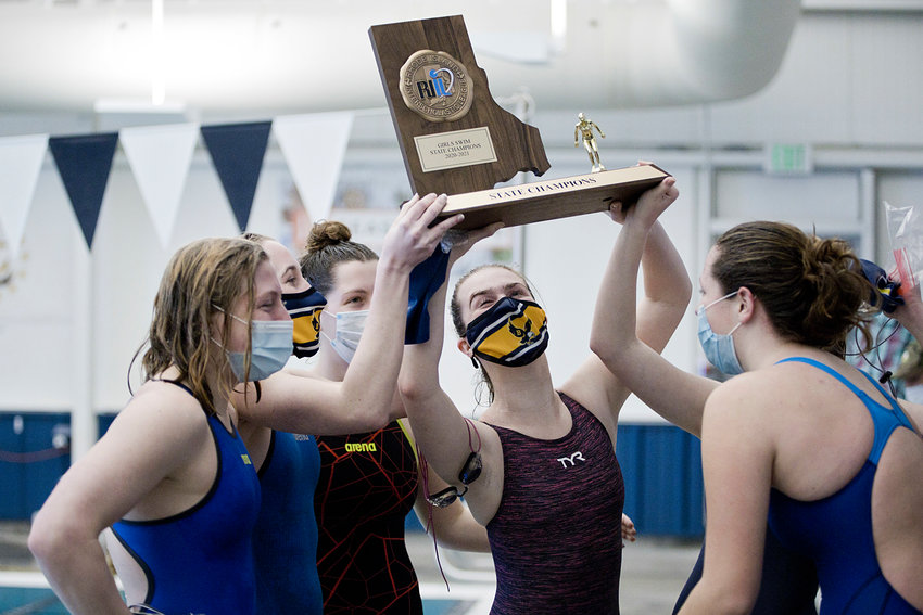 Members of the Barrington High School girls swim team celebrate with their trophy after winning the Division I State Championships, 48-46, against East Greenwich Sunday.