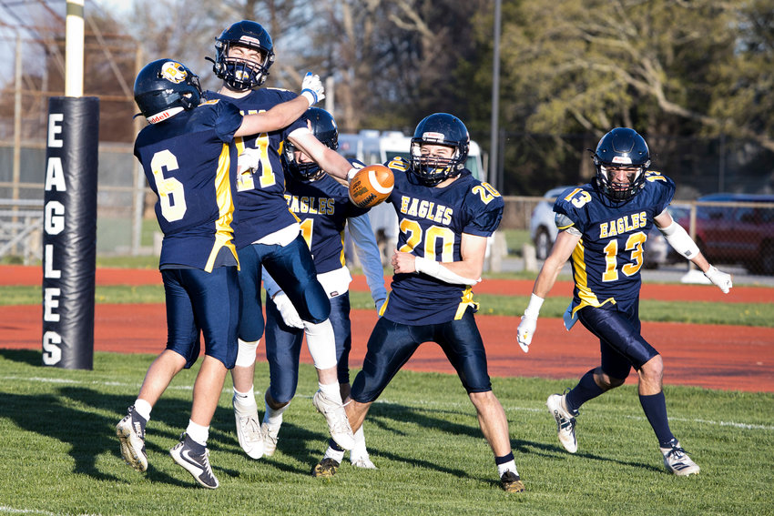 The Eagles celebrate a second quarter touchdown during the Division II semifinals, against Tolman, Friday.