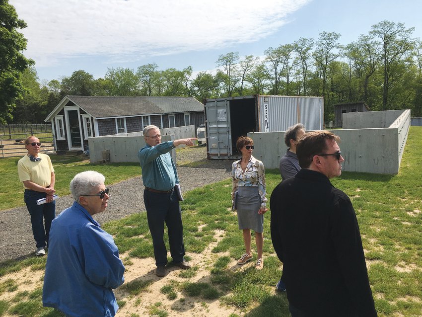 Mount Hope Farm representative Merritt Meyer (center) leads a tour of the property with Bristol Historic District Commission members (left to right) John Allen, Oryann Lima and Ben Bergenholtz. To his left is the farm&rsquo;s executive director, Sheri St. Germain. Behind them all is a foundation poured without any town review or approvals that triggered a cease and desist order, as well as a mandatory review of the farm&rsquo;s master plan with the town.