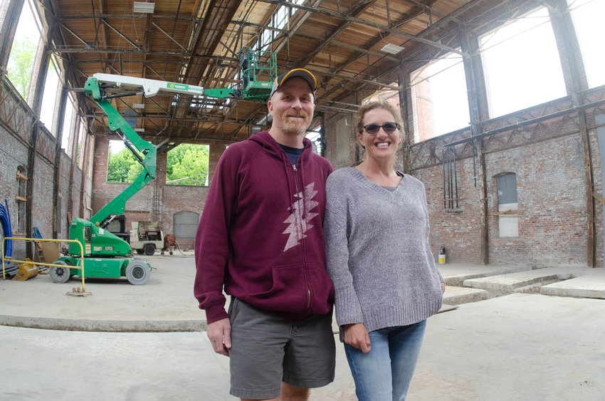 Todd Nicholson and Rebecca Ernst stand inside the 8,000-square-foot space that will house their Pivotal Brewing Company. Part of &ldquo;Unity Park,&rdquo; rising in the shell of the old Industrial Park off Wood Street, its construction has been delayed for many months because of supply line delays with their custom, historic windows.
