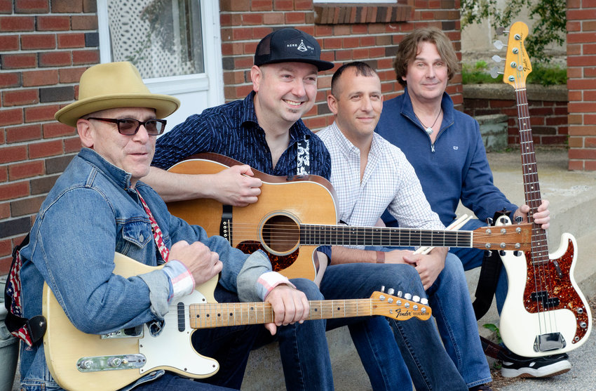 Andre Arsenault (second from left) poses with several of the members of the band which backed him up on the recording of &ldquo;02809&rdquo; and who will perform with him in concert at Roger Williams University on June 29 &mdash; (from left to right) Bob Tomassone, Scott Grimo and Eric Leffingwell.