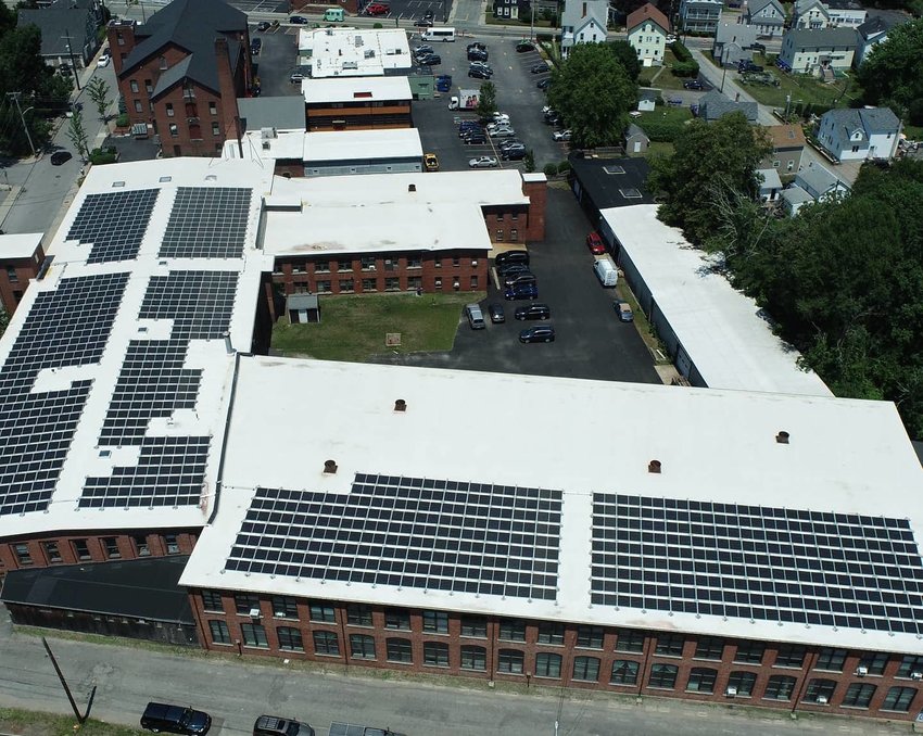 A drone photograph shows the new solar array atop the mills at 30 Cutler St. Child Street is at the top of the frame.