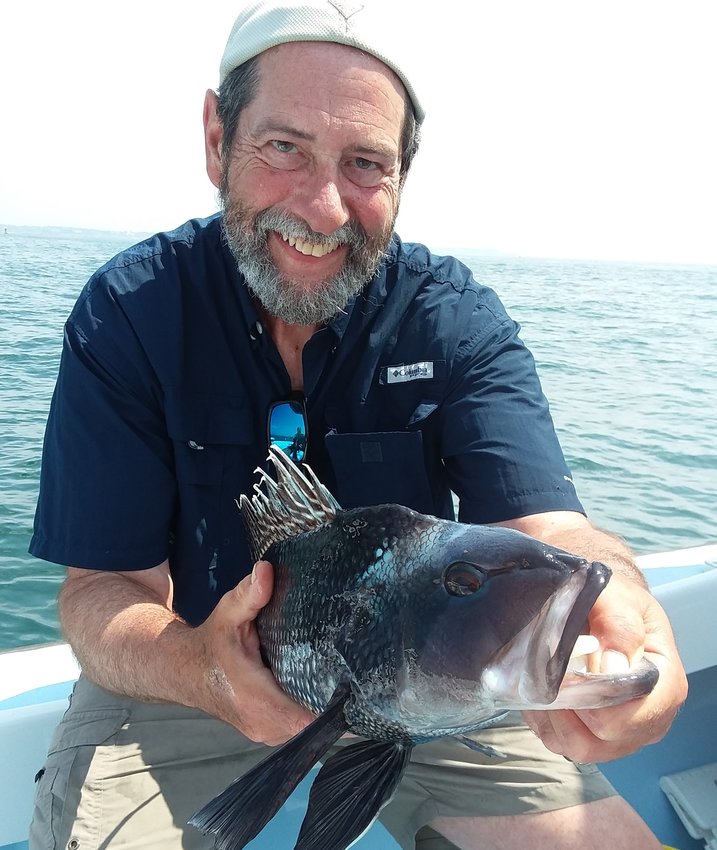 Black sea bass with attitude: Capt. Dave Monti with a black sea bass caught three miles south of the Sakonnet River. Black Sea bass season opened June 24.