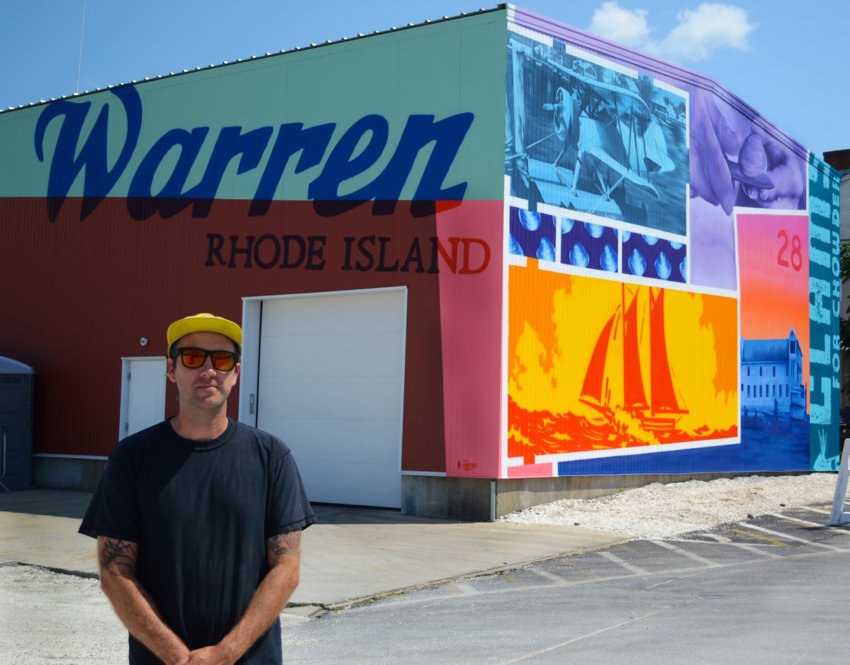 Greg Pennisten stands in front of his newly-finished mural, a spray-paint piece that celebrates the maritime history of Warren. It was commissioned by Blount Fine Foods in collaboration with The Avenue Concept.