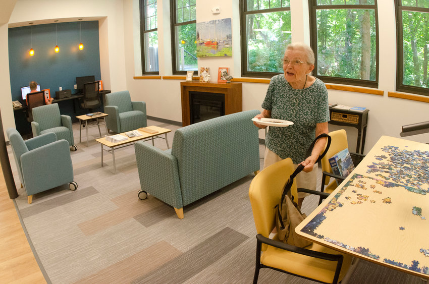 A resident works on a puzzle inside the lounge area at the recently-renovated Peck Center for Adult Enrichment in Barrington.