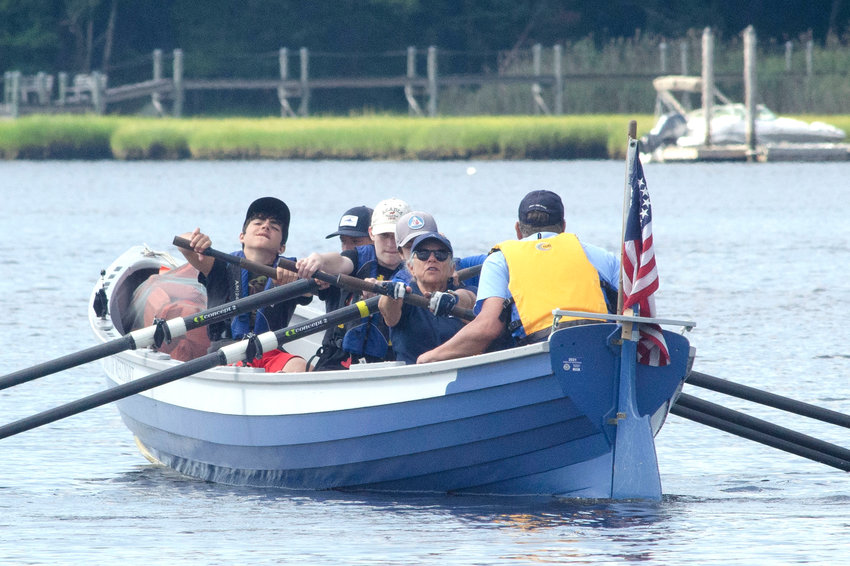 Rowers Finnegan Hall, 14, Zach Carter, 14, Ethan Stewart, 14, and James Albanese, 11, row a Cornish pilot gig with Dharma Voyage instructors Janet Hadley and Don Dufault down the East Branch of the Westport River during rowing class last Monday, August, 2.